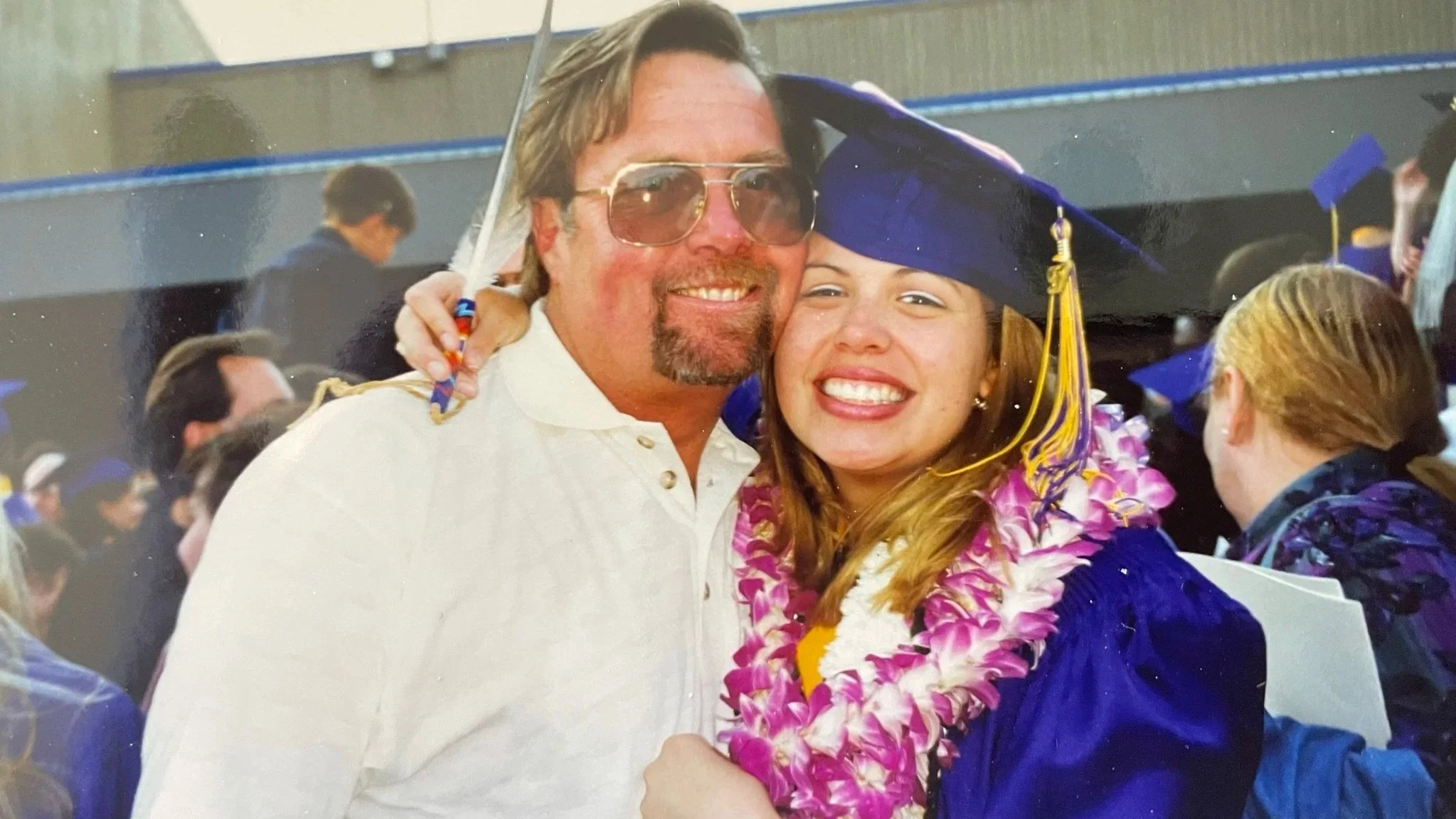 Bettina smiling at graduation with her father