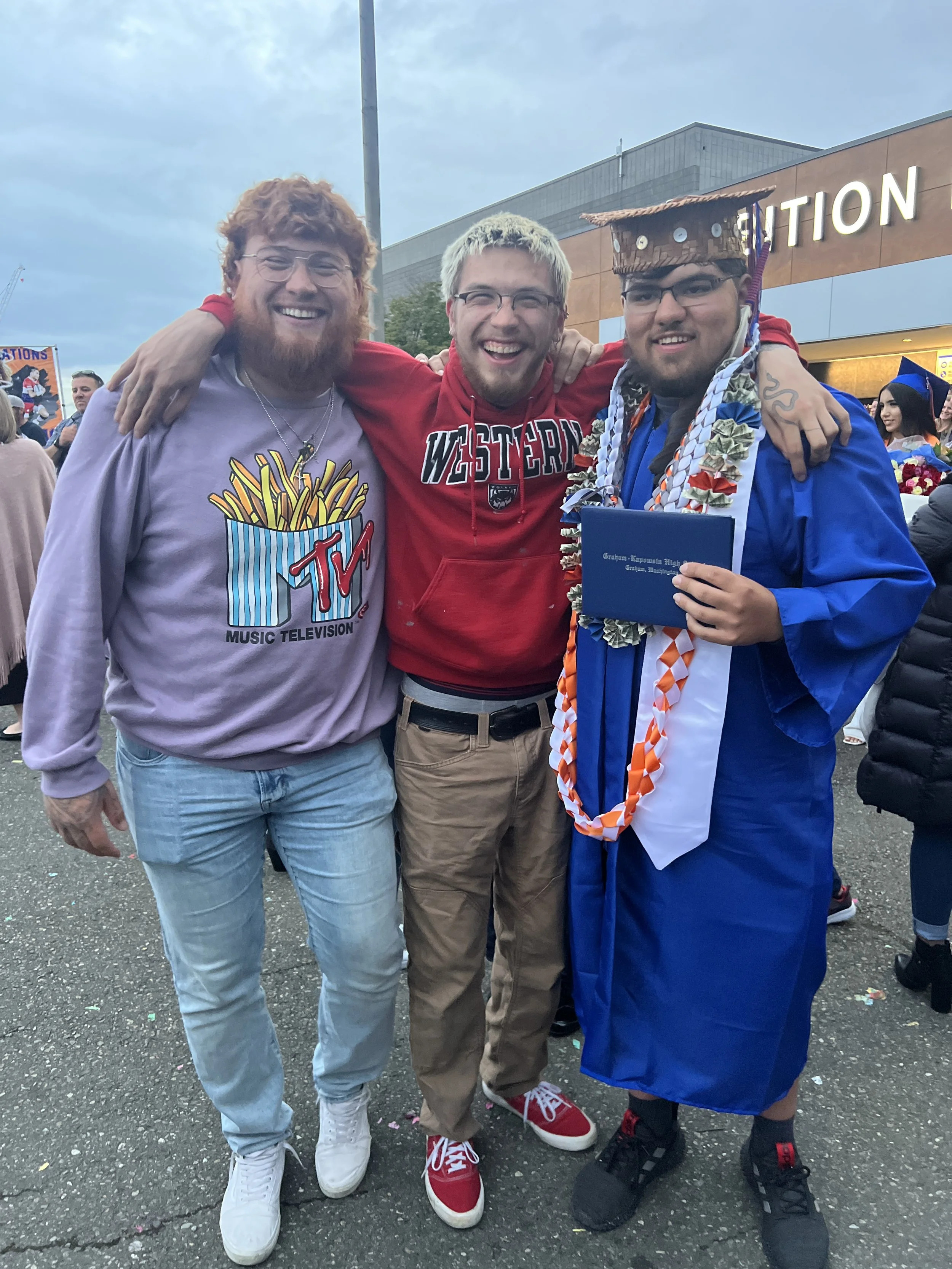 Bettina's sons standing together, smiling, at graduation