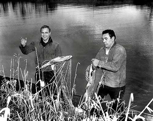 Historic photograph of tribal members fishing on the river